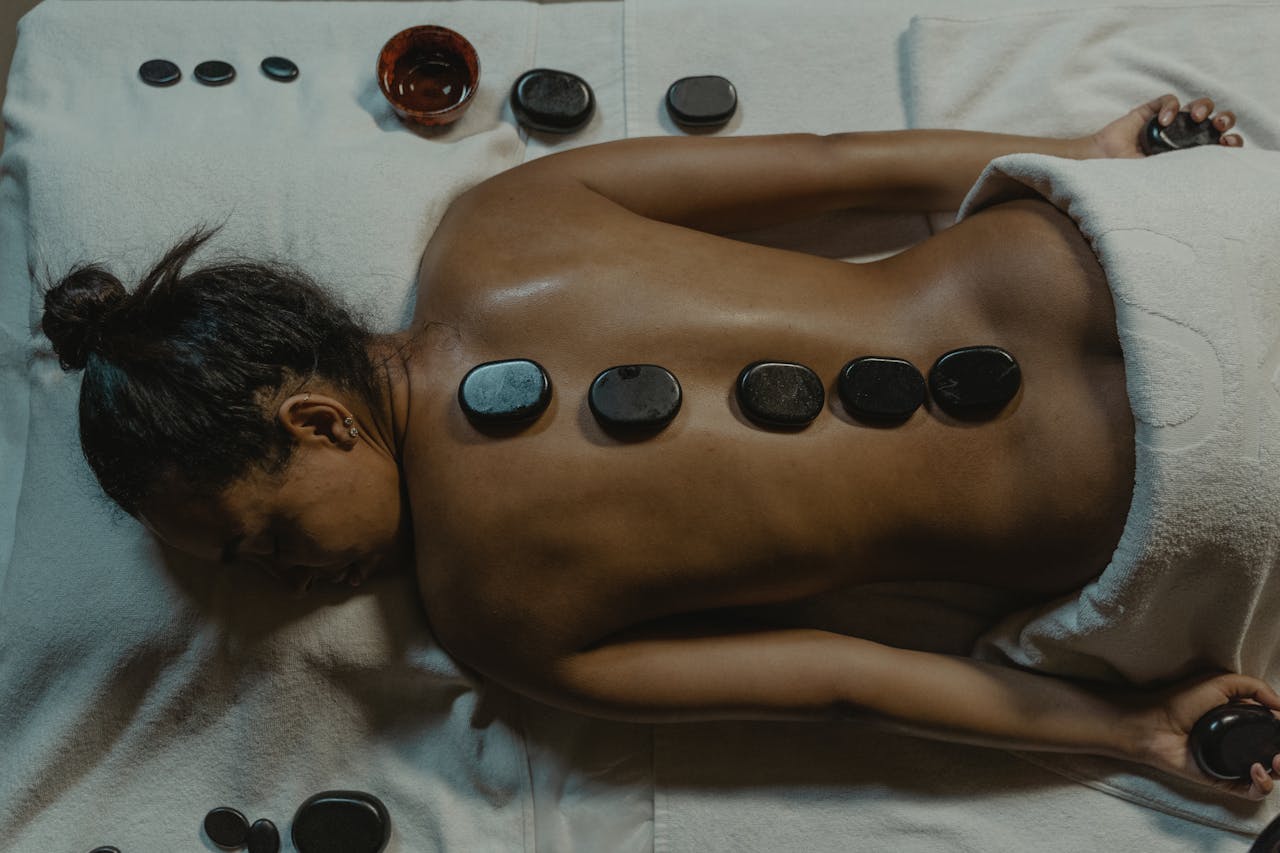 who-we-are-img A serene spa scene with hot stone massage therapy focusing on health and relaxation.