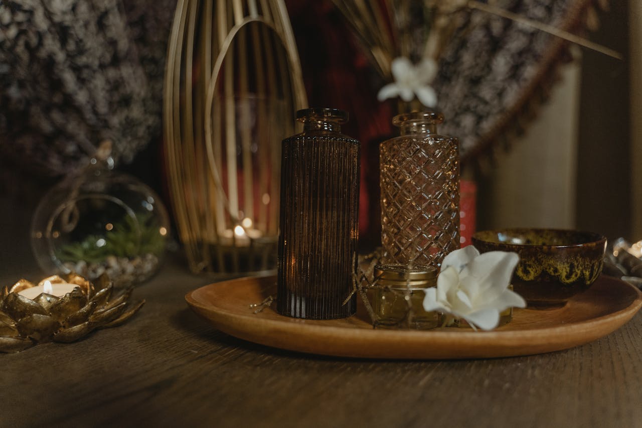 services-03 Serene spa setting with elegant candlelight and decorative vases on a wooden tray.