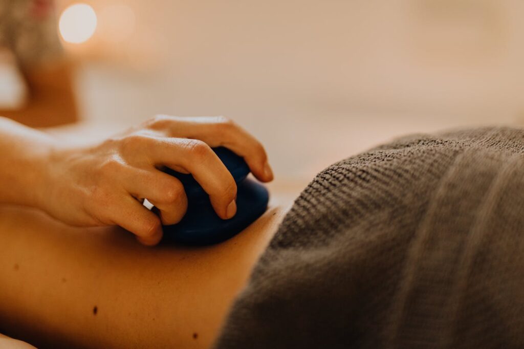 How Successful Entrepreneurs Maximize Productivity Hands applying relaxing massage therapy with hot stones in a calming spa environment.