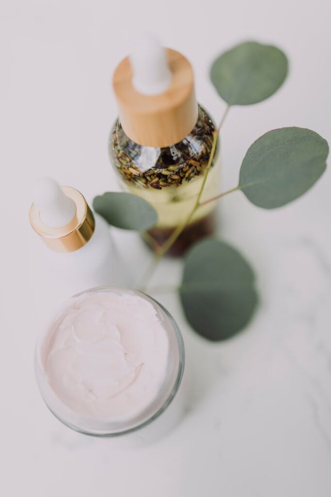 Overcoming Challenges Lessons Every Entrepreneur Must Learn Minimalist skincare display featuring creams and oils with eucalyptus leaves.